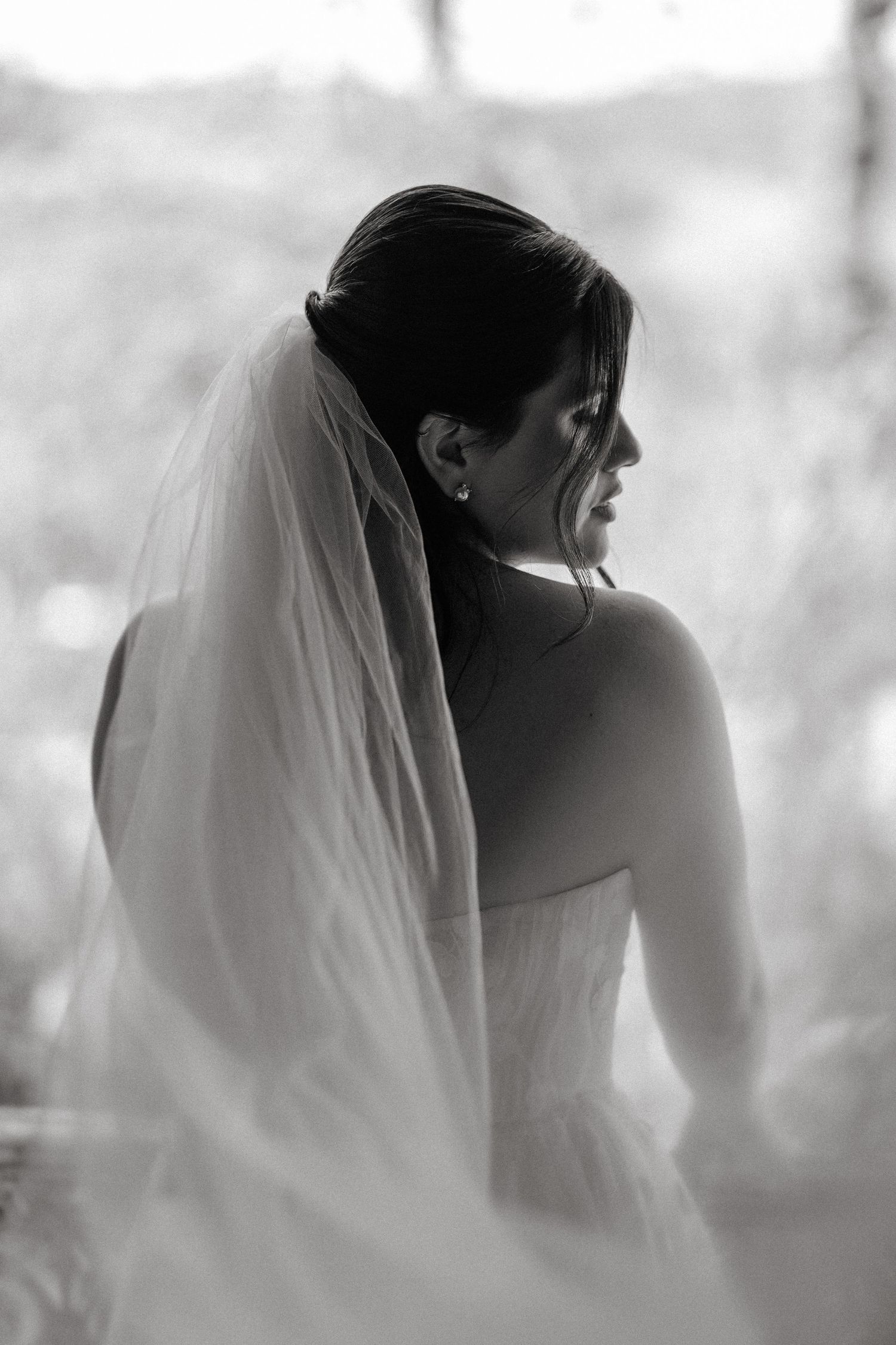 A series of black and white photos showing a bride in profile view with a flowing veil creating a dreamy effect.