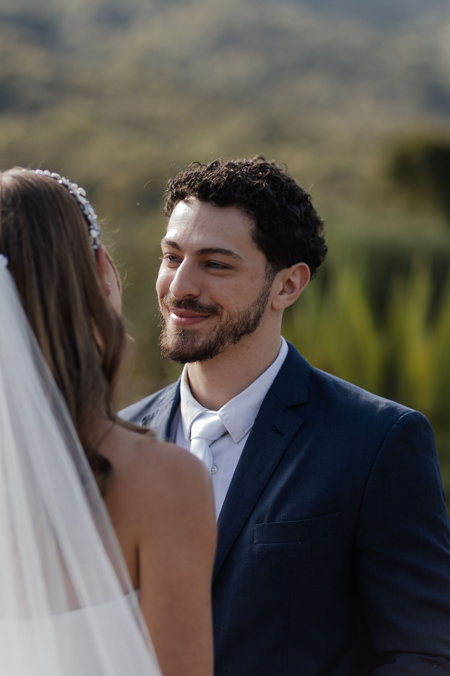 Close-up sequence of intimate wedding moments between newlyweds during golden hour in outdoor ceremony.