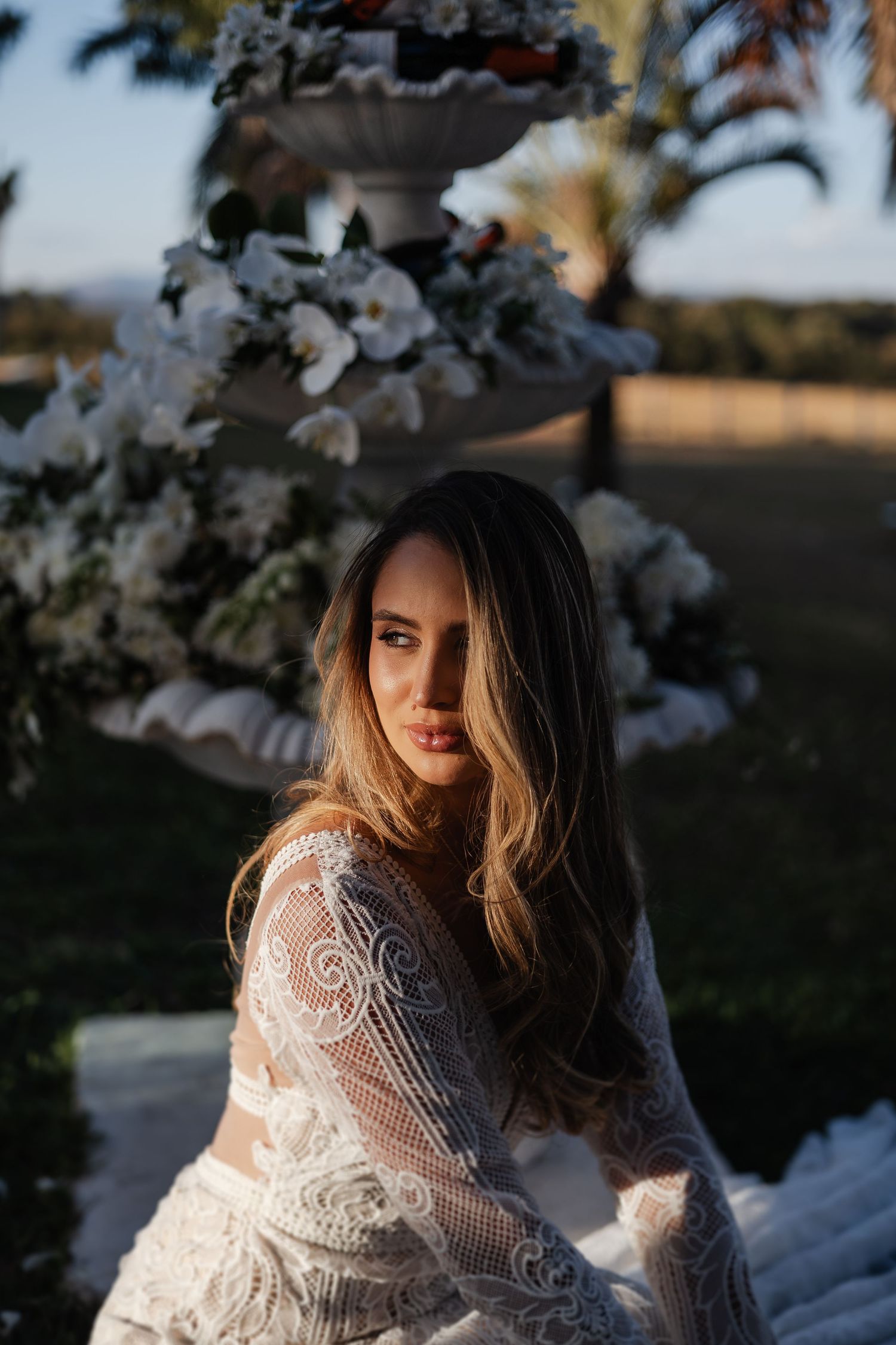 Ethereal bridal portrait series showing delicate lace details and spring blossoms at golden hour.
