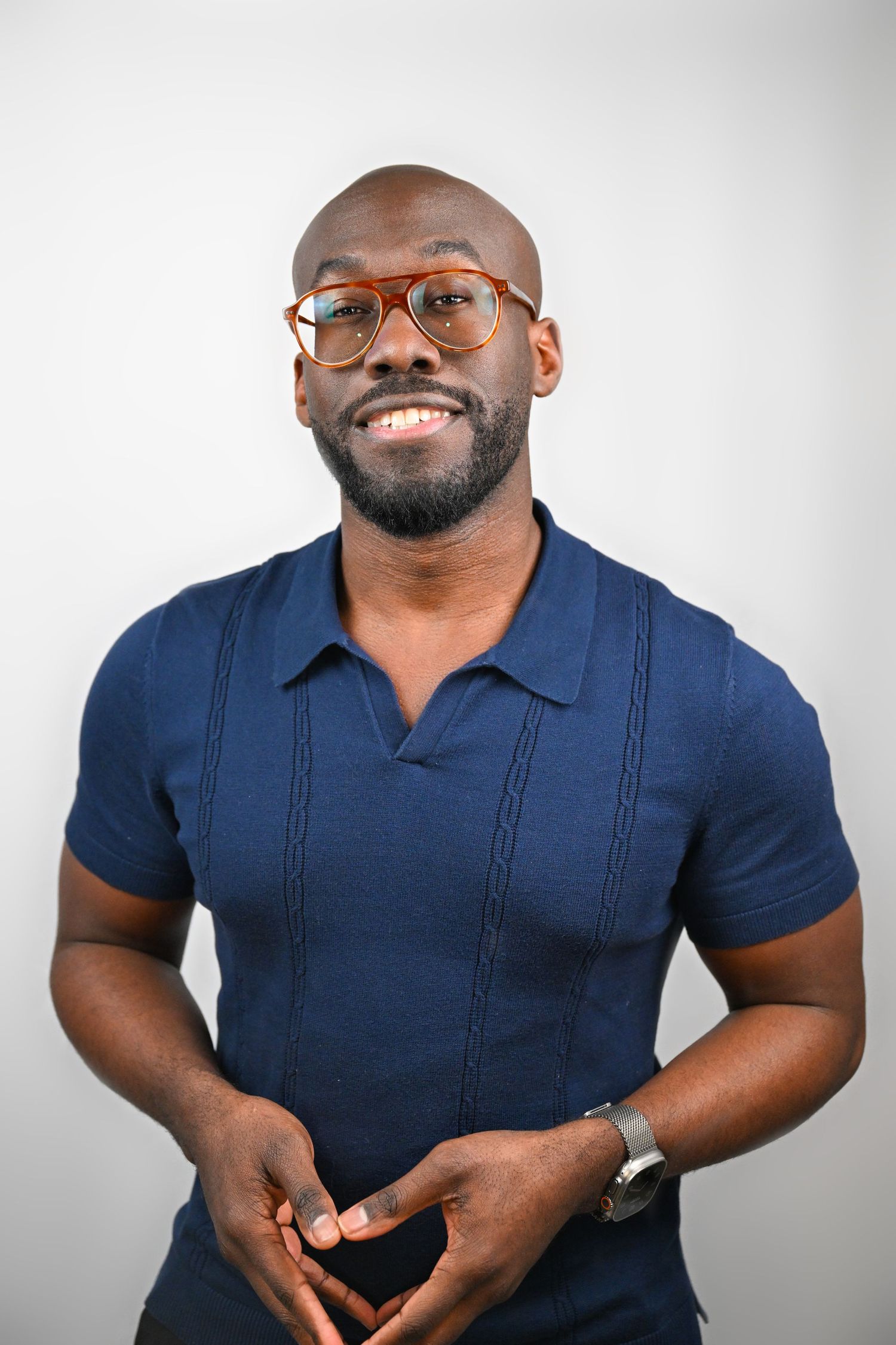 Dynamic poses of someone wearing fitted navy polo shirt against white background.