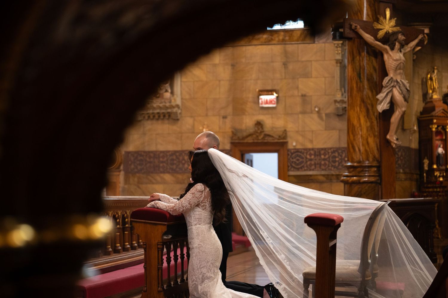 A person in a flowing white dress dances gracefully through the aisles of a historic stone church interior.