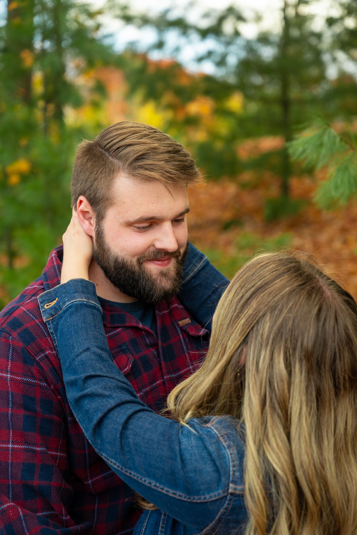 An intimate moment captured against vibrant fall foliage.