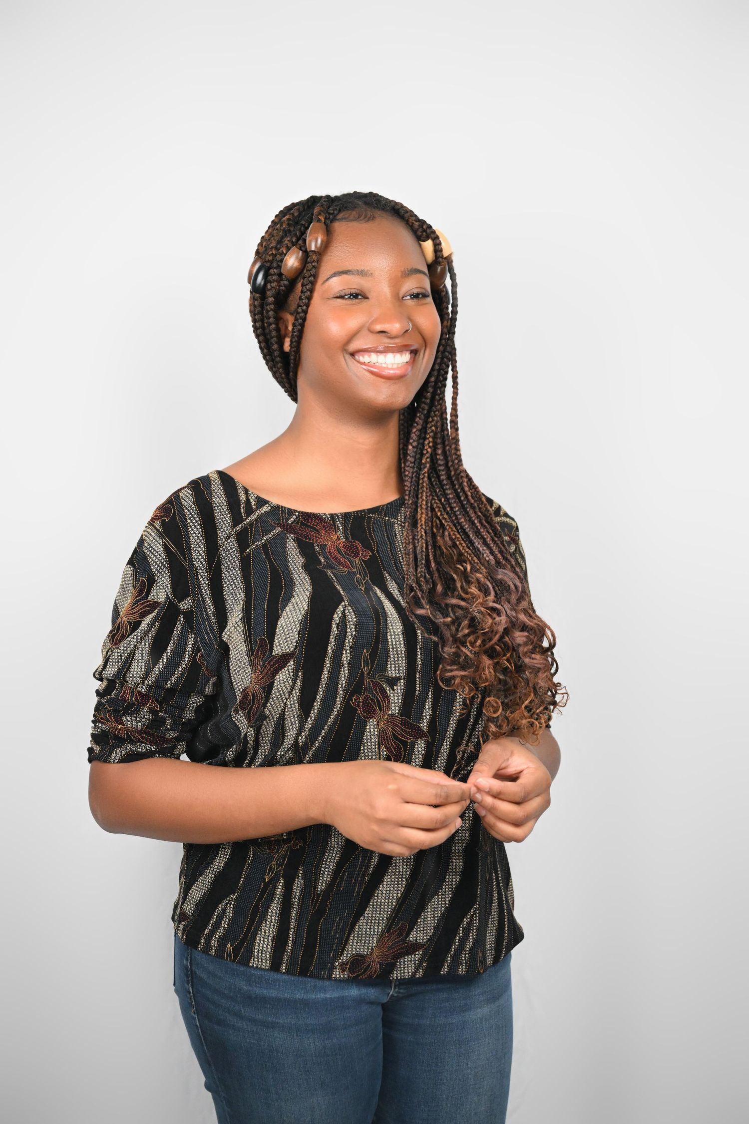 Casual portrait showing stylish braids and zebra-print top with natural lighting.