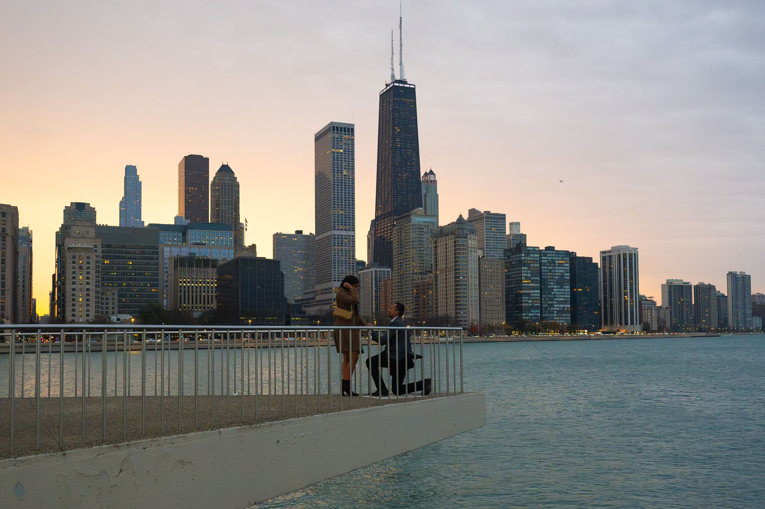 Chicago skyline view from Lake Michigan pier at golden hour.