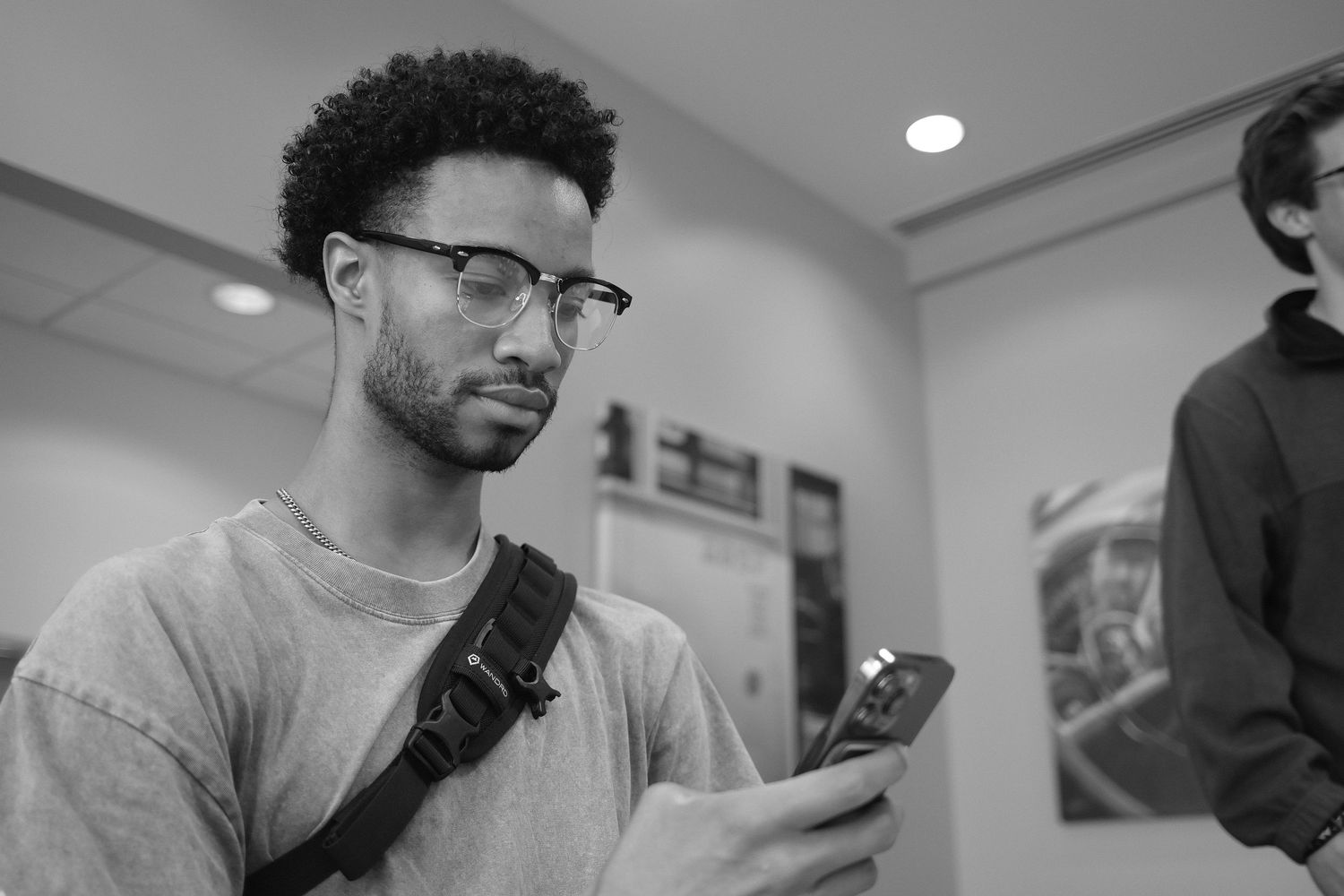 People checking their phones in a modern office setting.