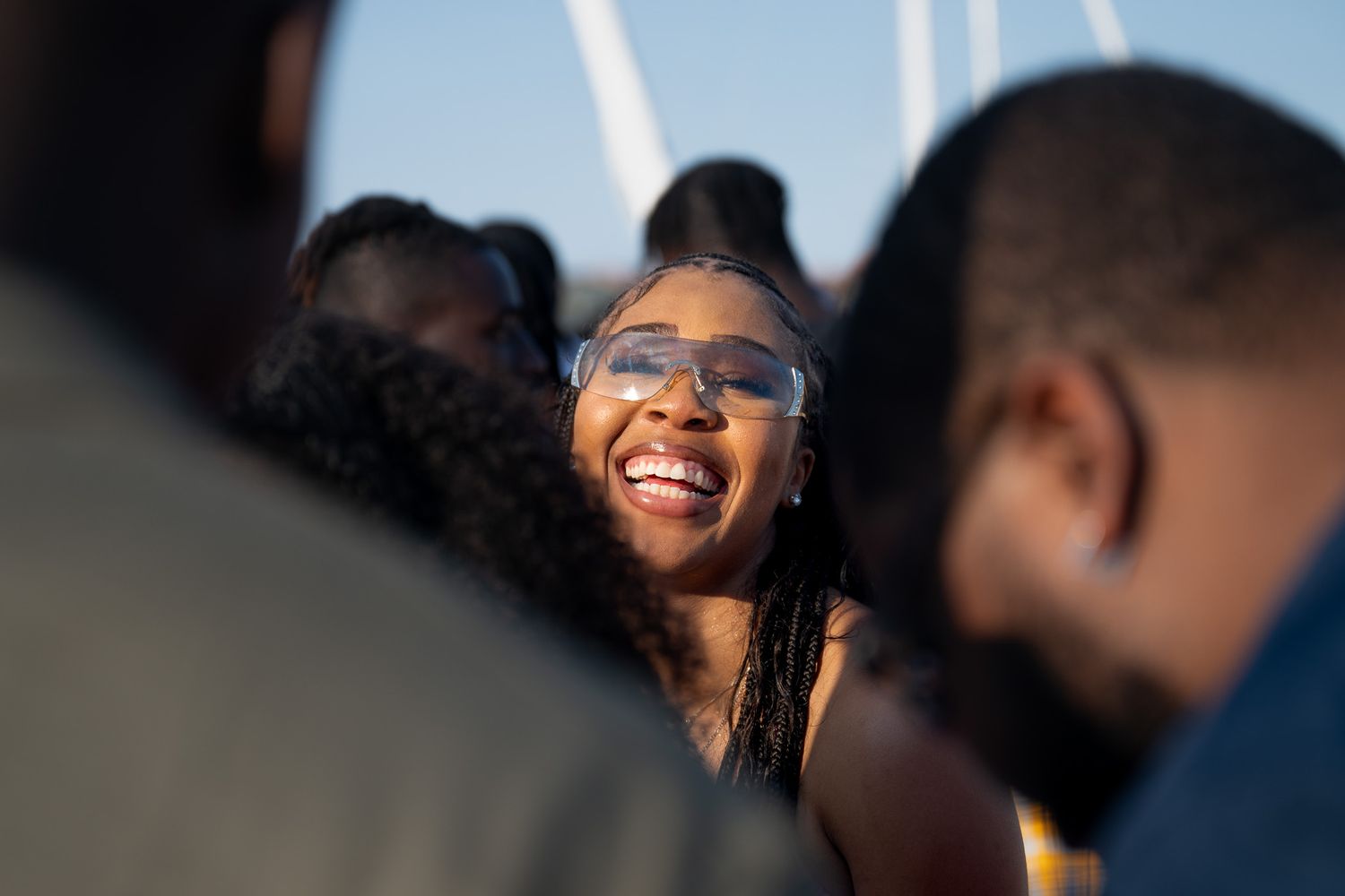 Joyful moment captured against sunlit marina background.