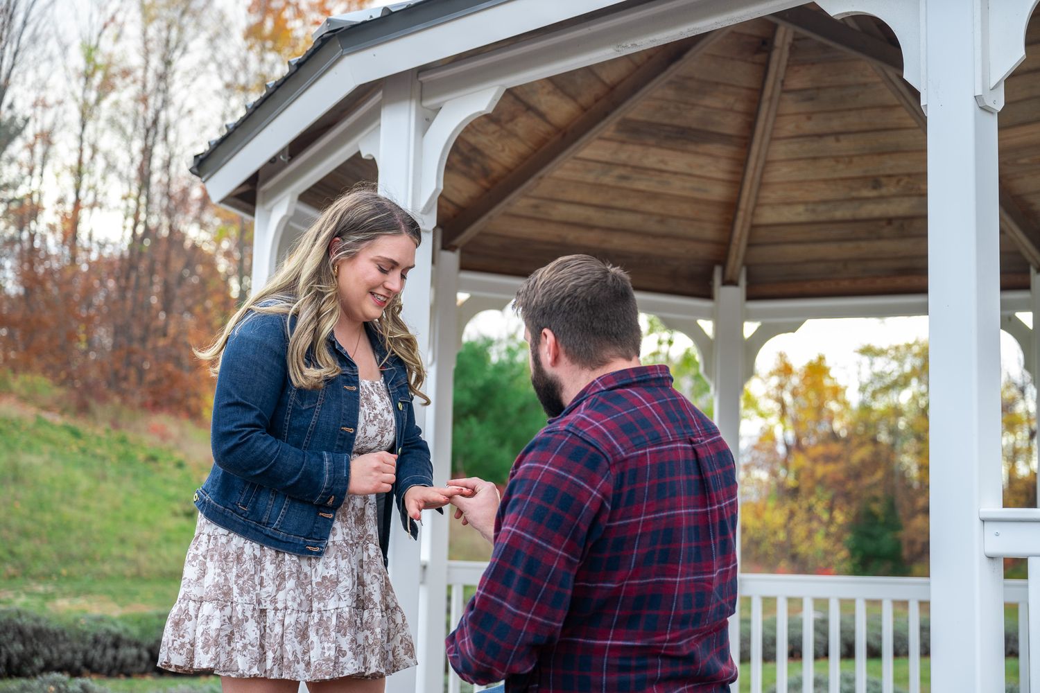 A heartfelt moment shared between two people in a white gazebo.