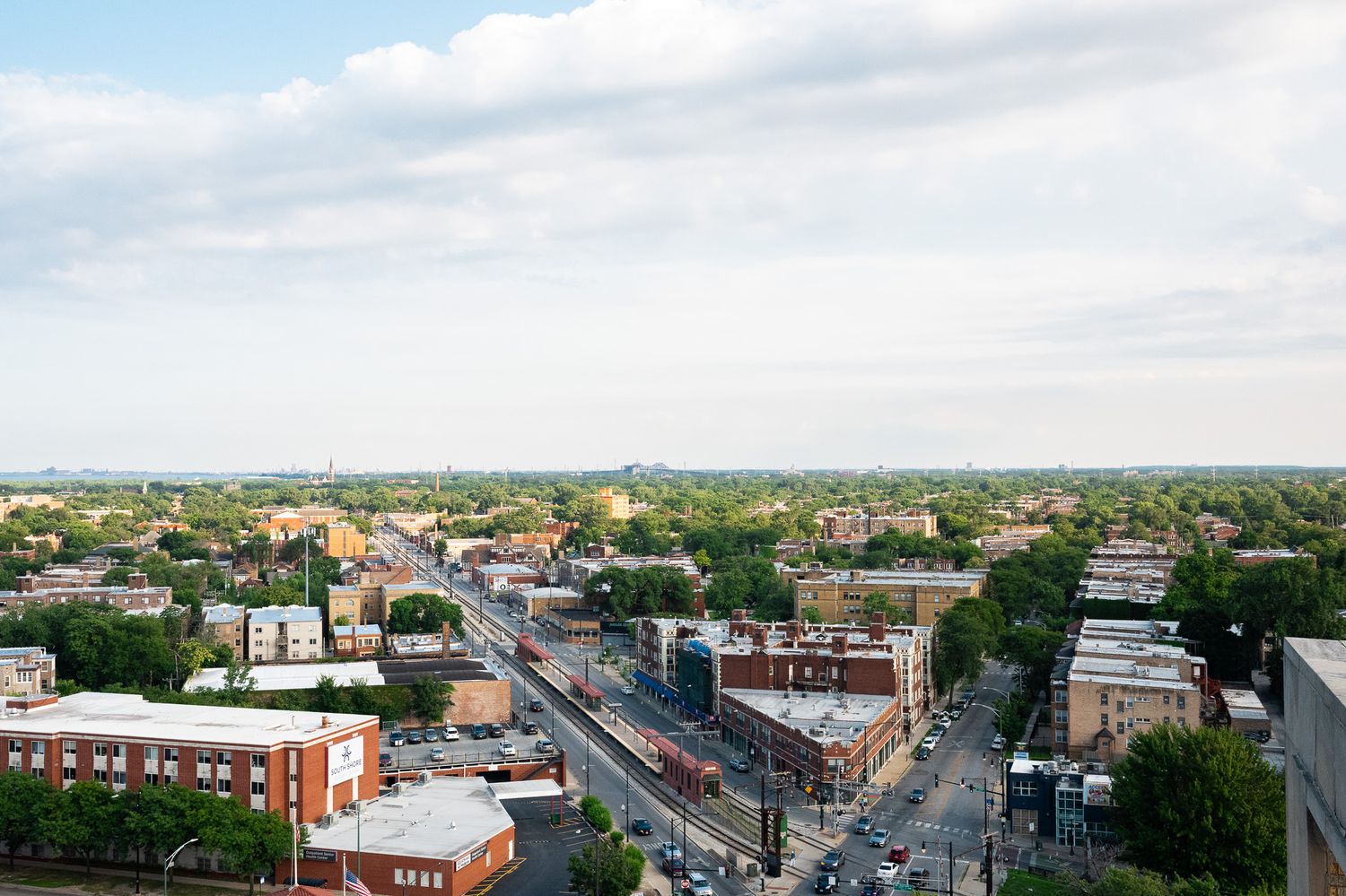 Aerial cityscape view showing residential buildings and intersecting streets on a clear day.