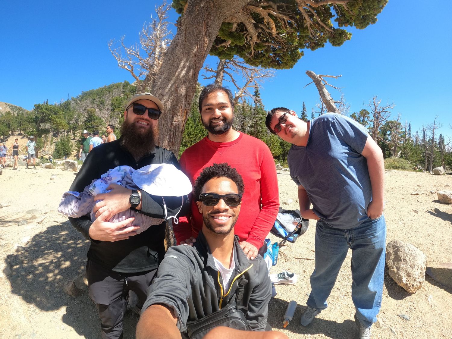 Friends enjoying a sunny outdoor adventure in a desert landscape.