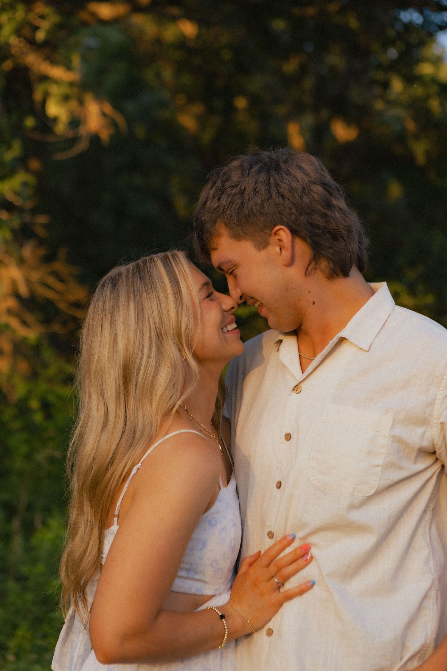 Cute young couple portrait of them smiling and wearing white
