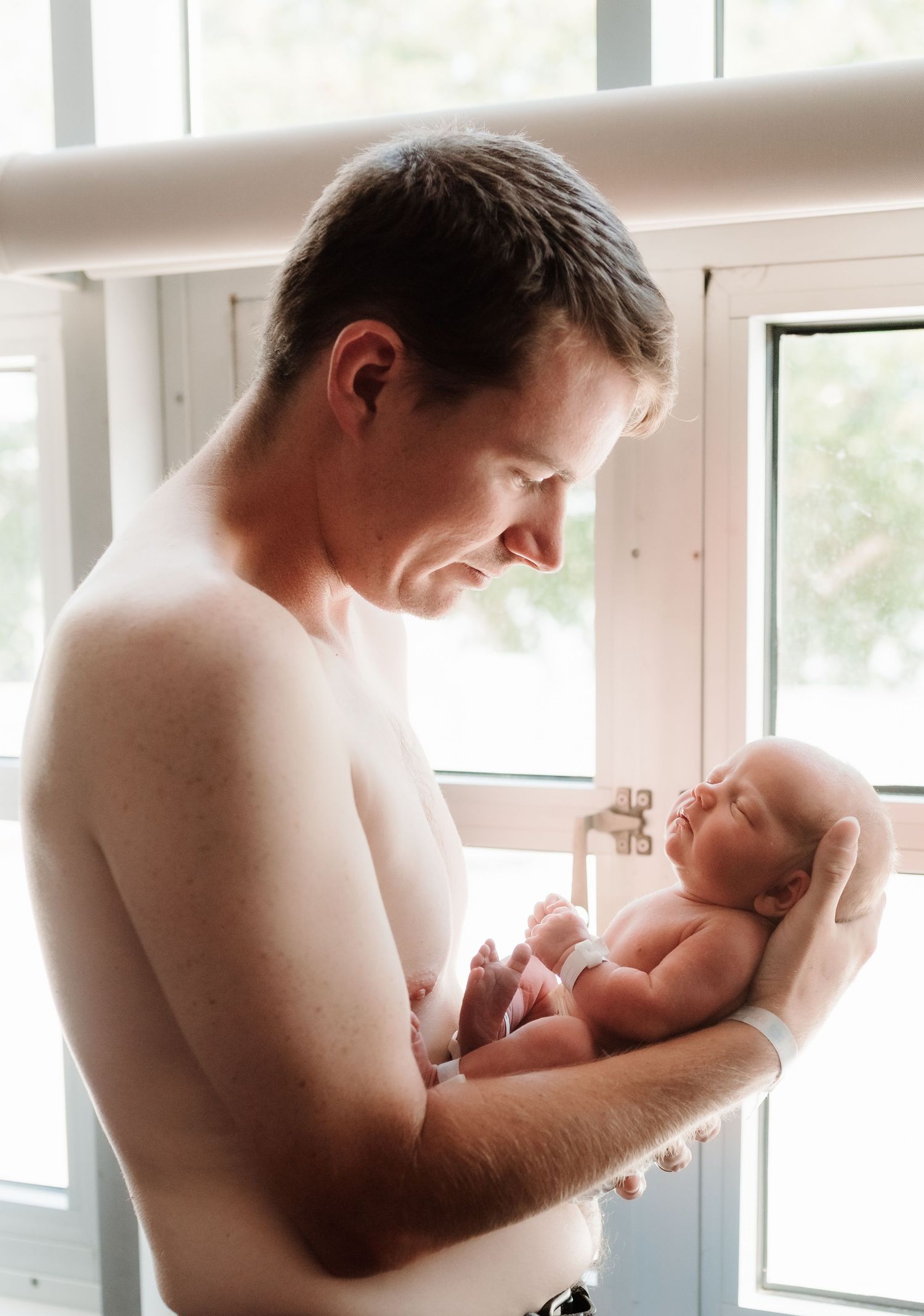 A tender series of close-up photographs showing a parent bonding with a newborn baby in a bright sunlit room.
