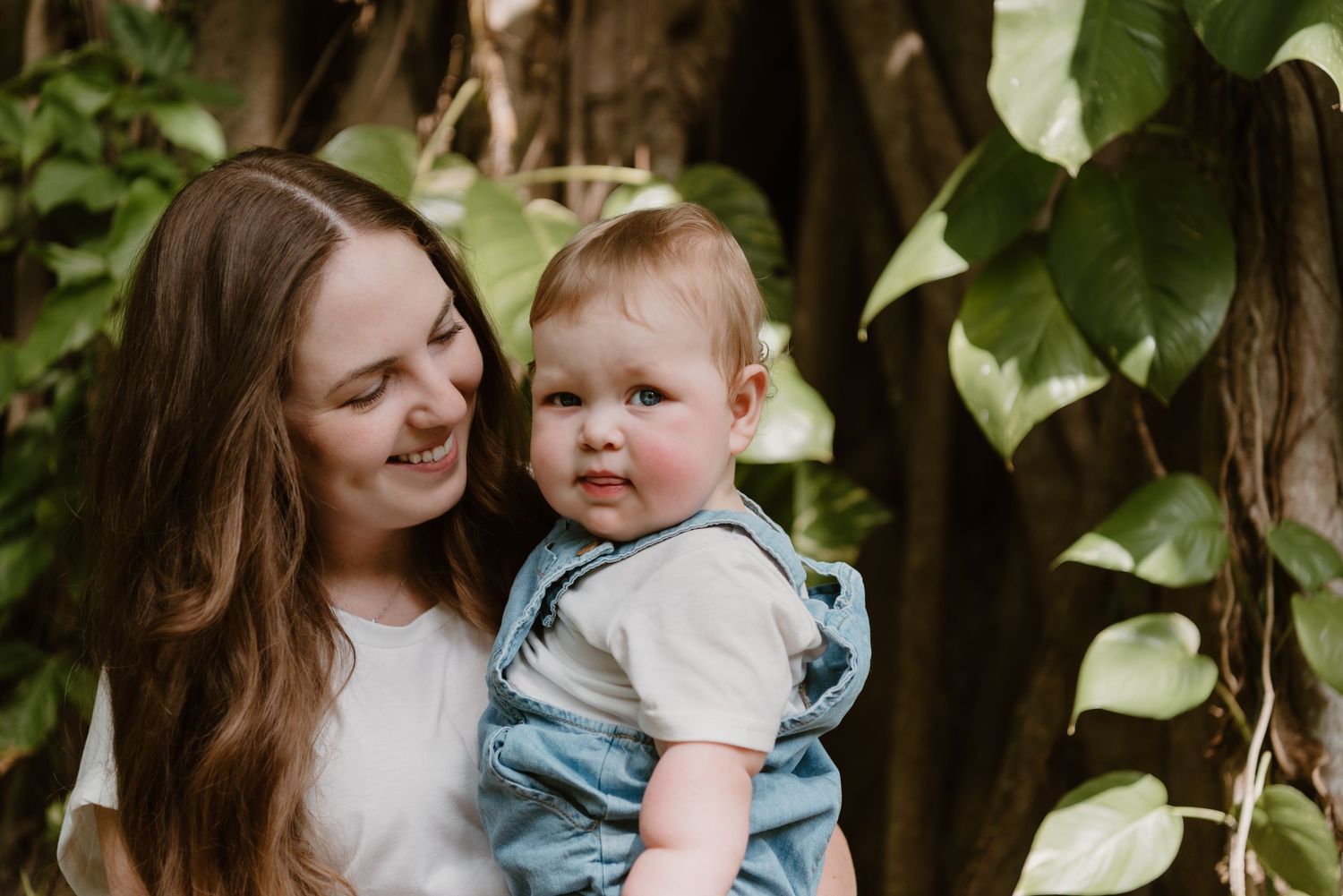 Heartwarming collection of candid family photos showing tender moments between parent and baby in a garden setting.