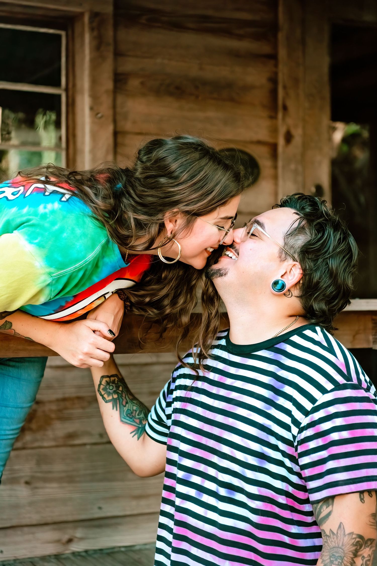 A couple in matching striped shirts share a playful moment in a series of progressive photos showing them leaning in for a kiss.