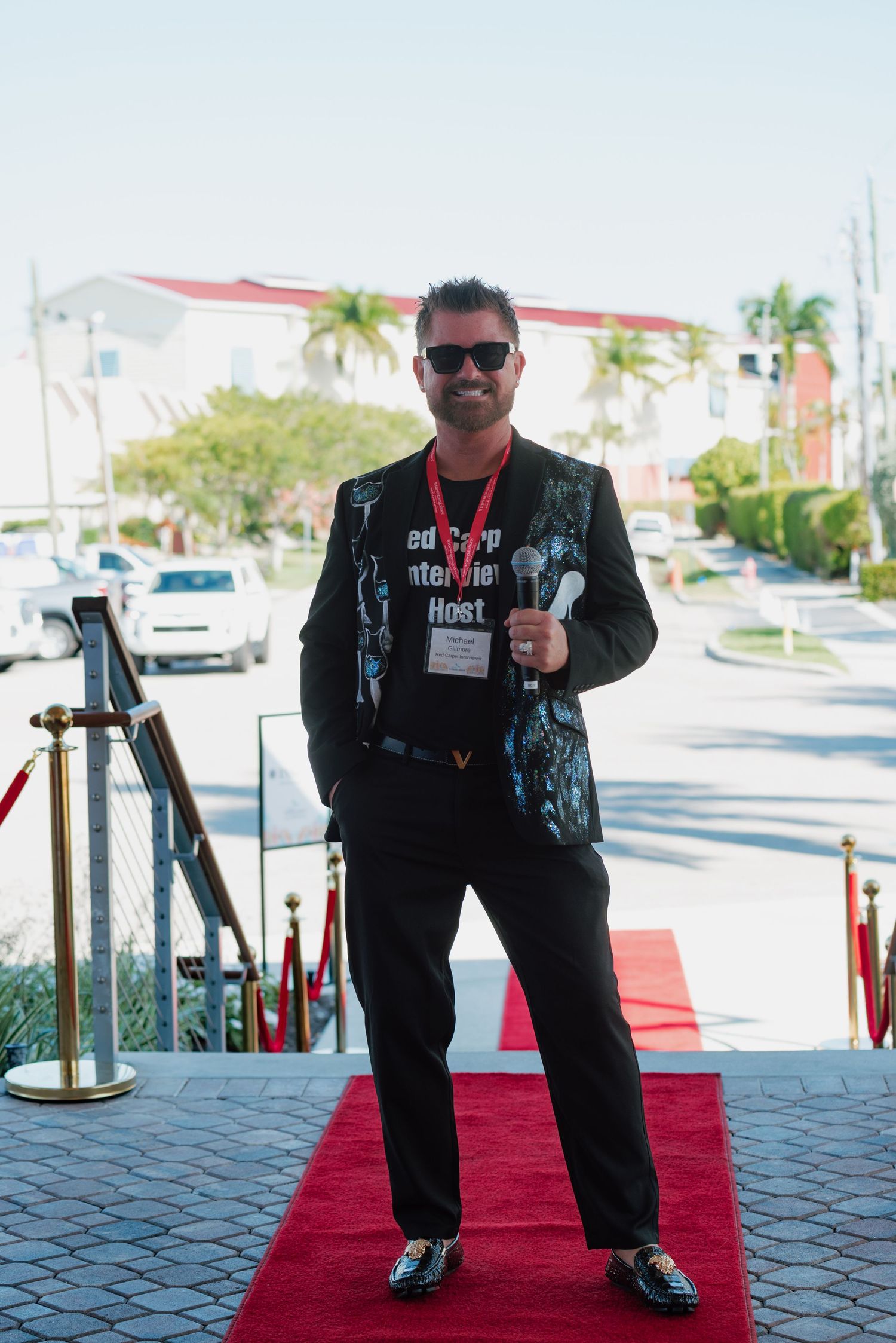 A sequence of photos showing someone in black attire posing on a red carpet walkway outdoors.