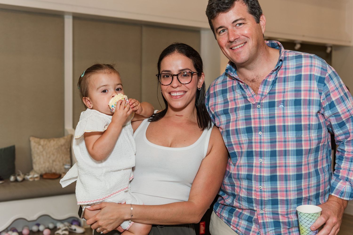 A montage of candid family moments showing parents and a baby interacting in an indoor setting.