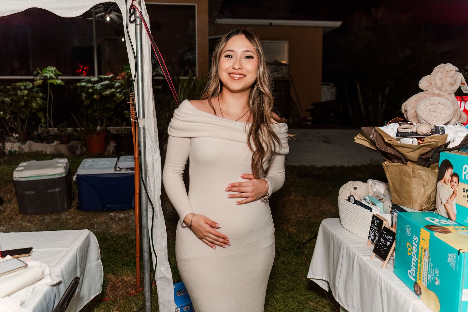A collection of candid moments from a baby shower celebration showing white decorations and party festivities.