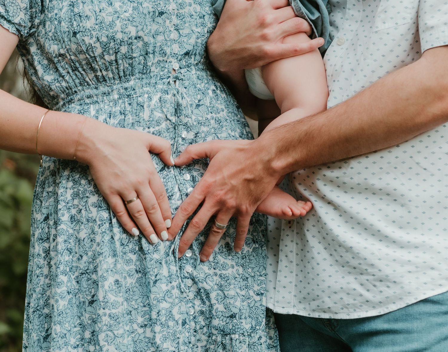 Close-up series of hands showing a gemstone engagement ring against a seafoam green dress and white top.