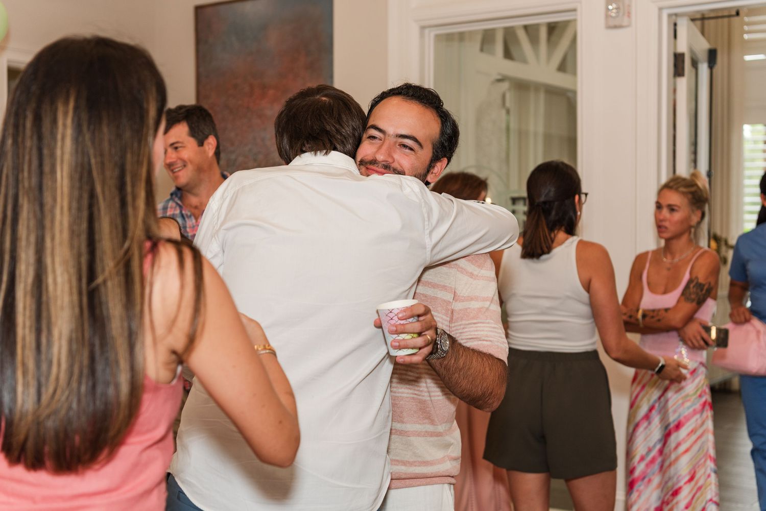People gather for a dance lesson in an intimate indoor setting, practicing dance moves together.