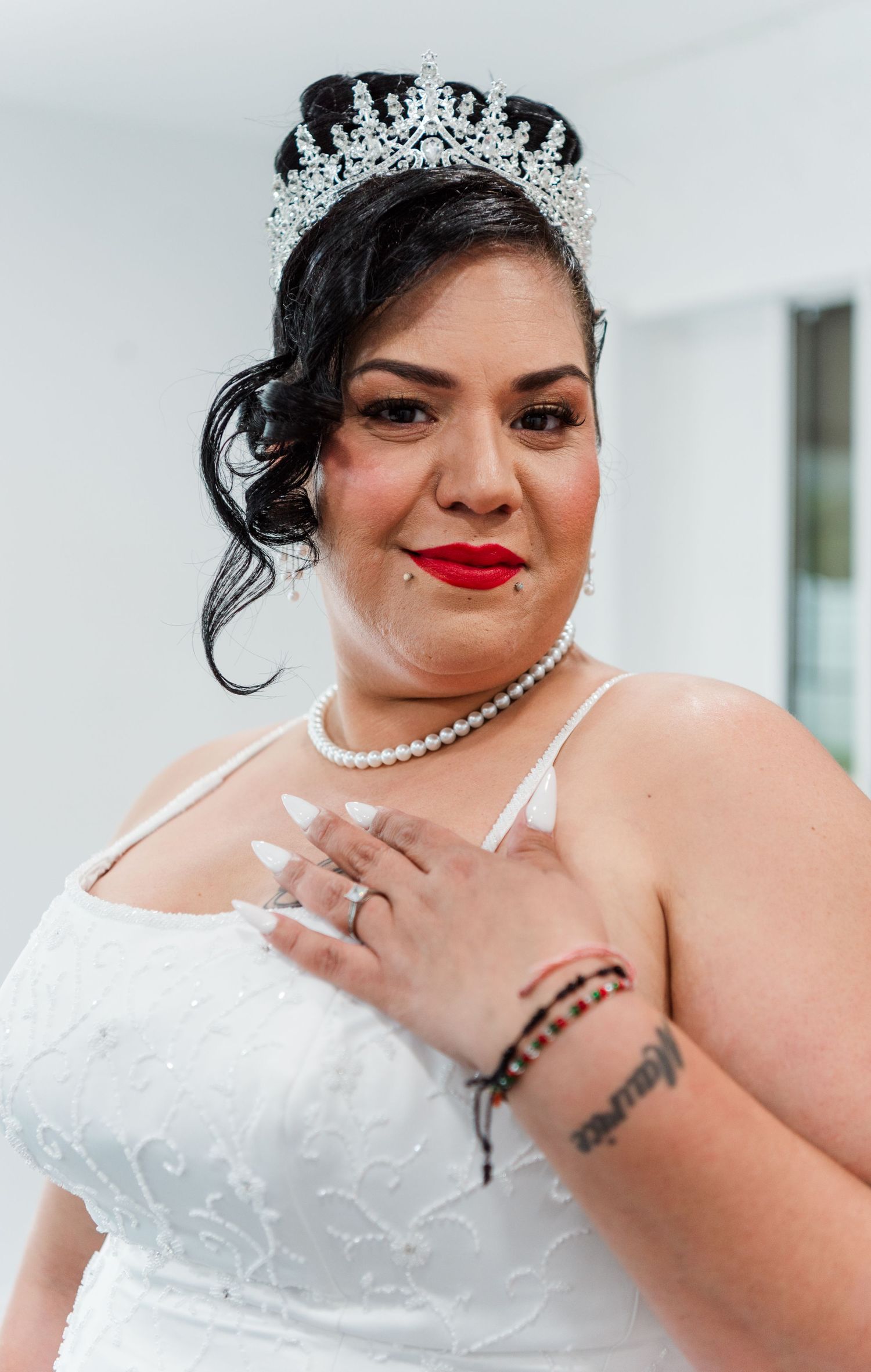 Close-up bridal portraits showing details of white wedding dress, pearl necklace, and tiara accessories.