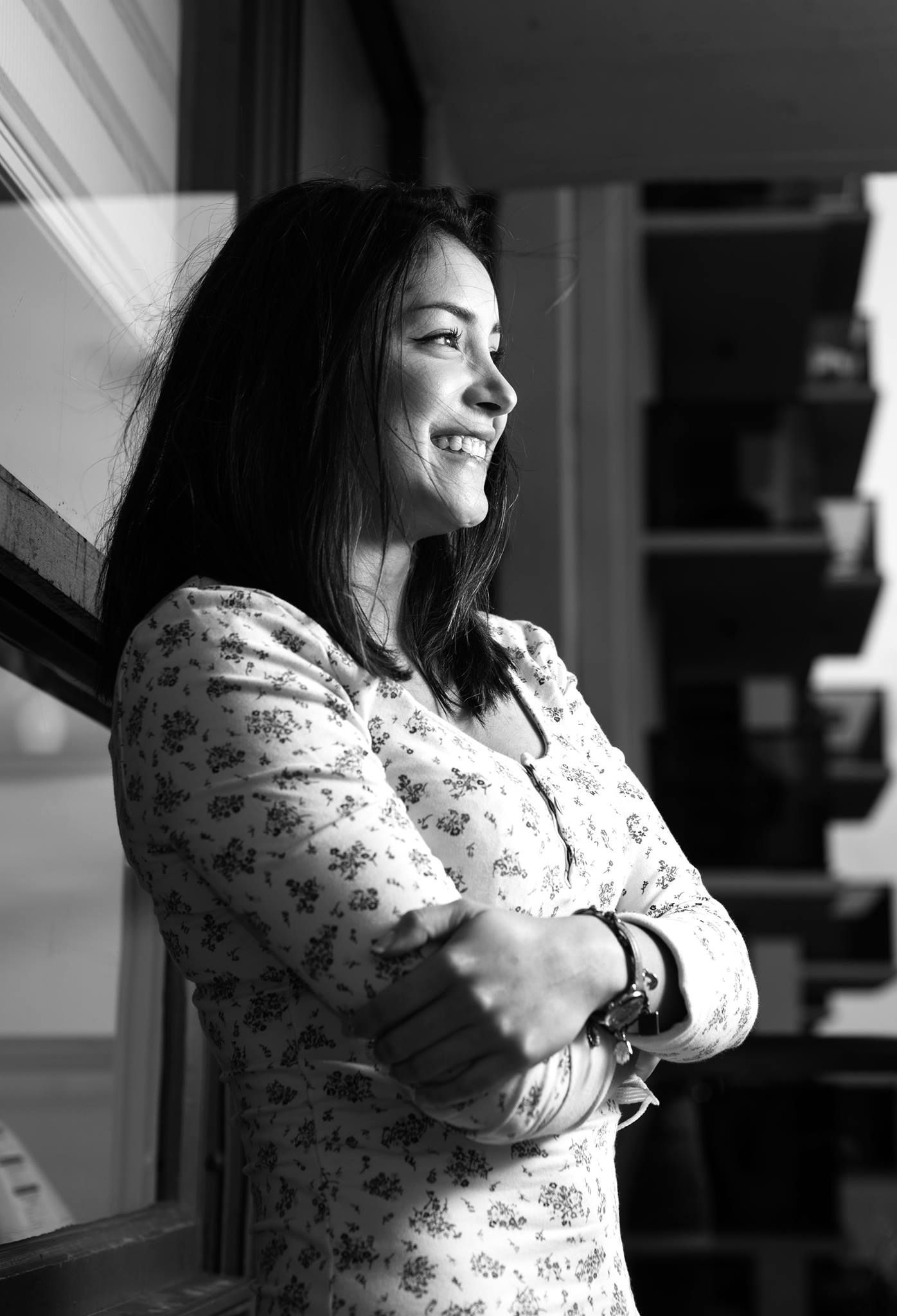A person in a floral print shirt is captured in a series of black and white portraits with dramatic lighting.