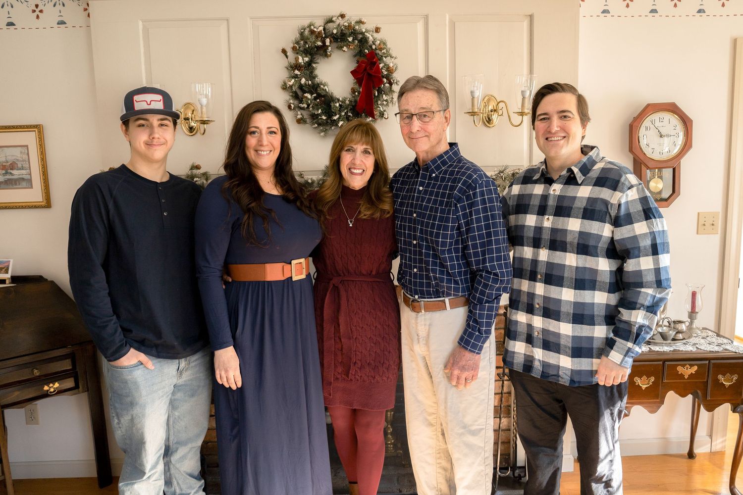 Family group gathered together in living room for holiday photo.