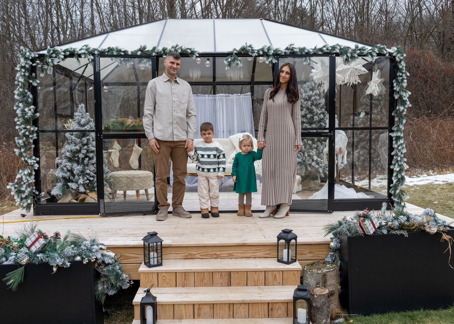 Winter wedding venue decorated with white floral arrangements and lanterns on wooden platform.