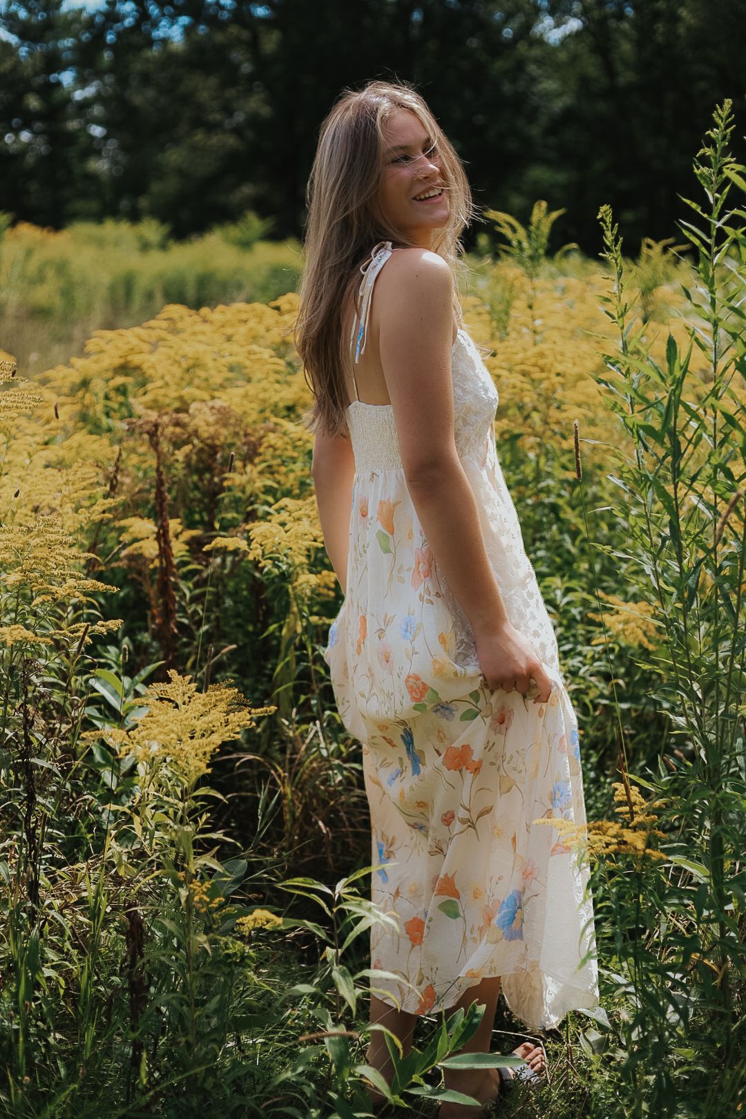 A light summer dress flows in the breeze amid a field of golden wildflowers.