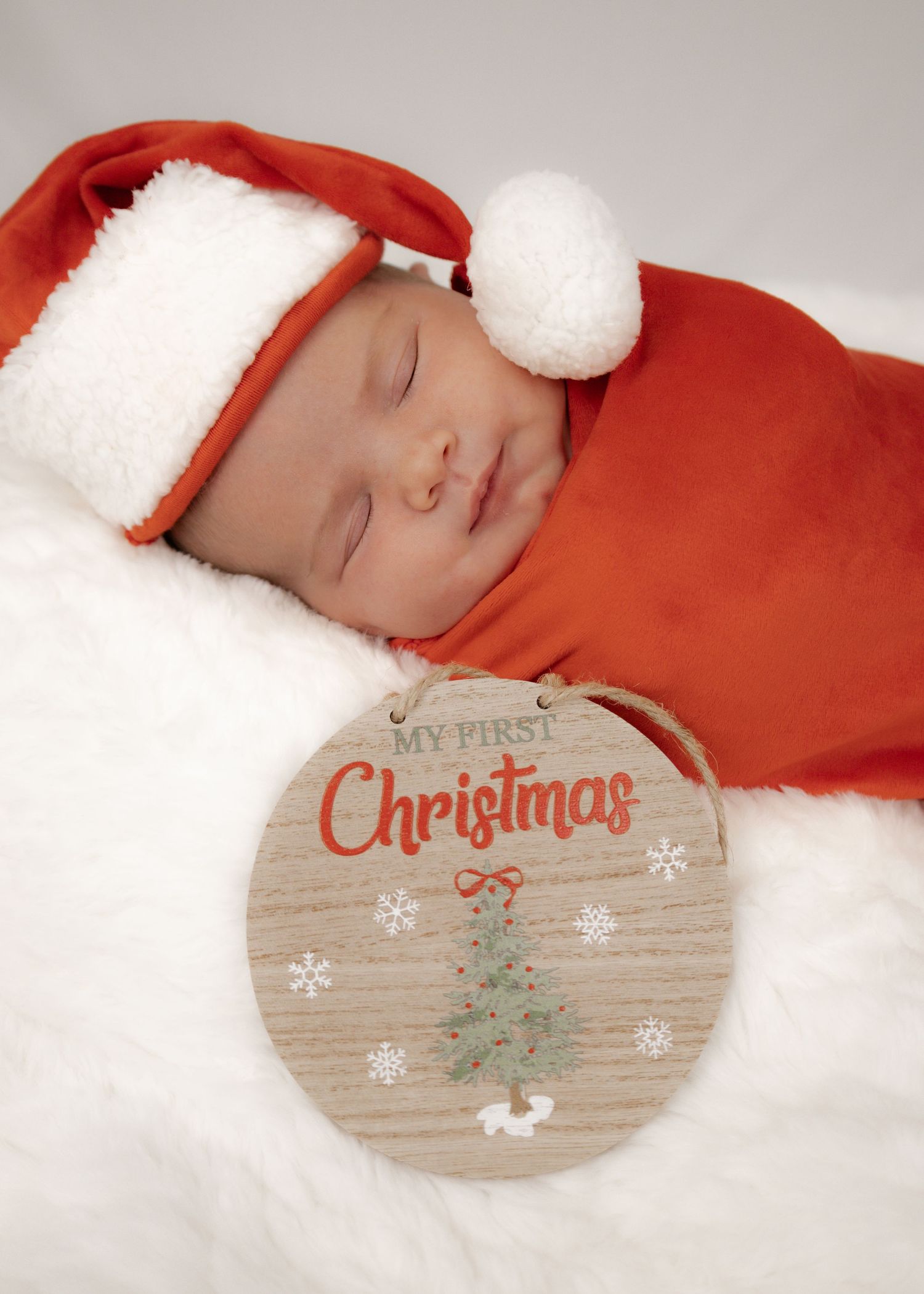 A festive Christmas scene with wooden decorations and soft white snow.