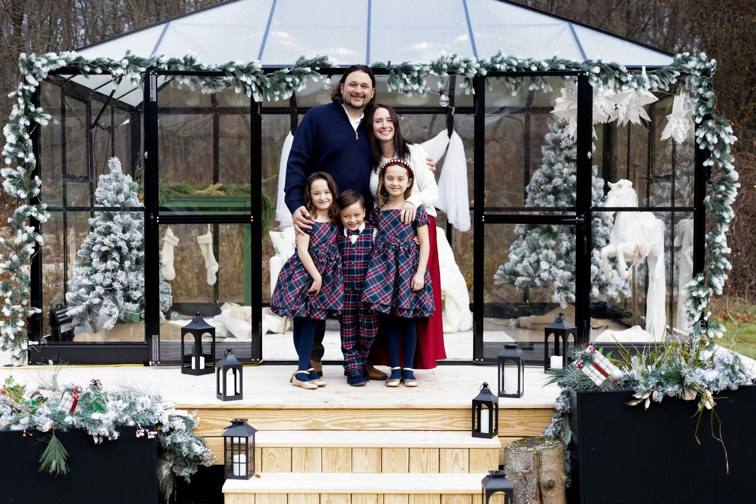 Festive outdoor gathering space with white tent and holiday decorations.