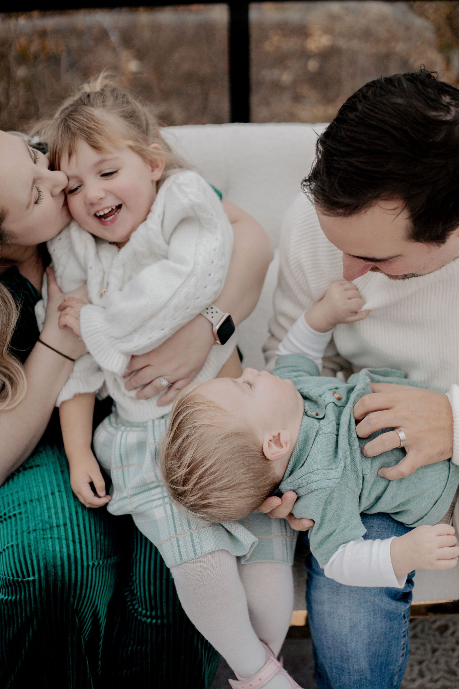 Intimate family moments captured in studio with white and mint green color scheme.