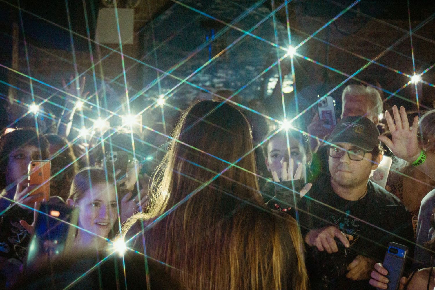 Sofia Isella crowd photo bright phone lights