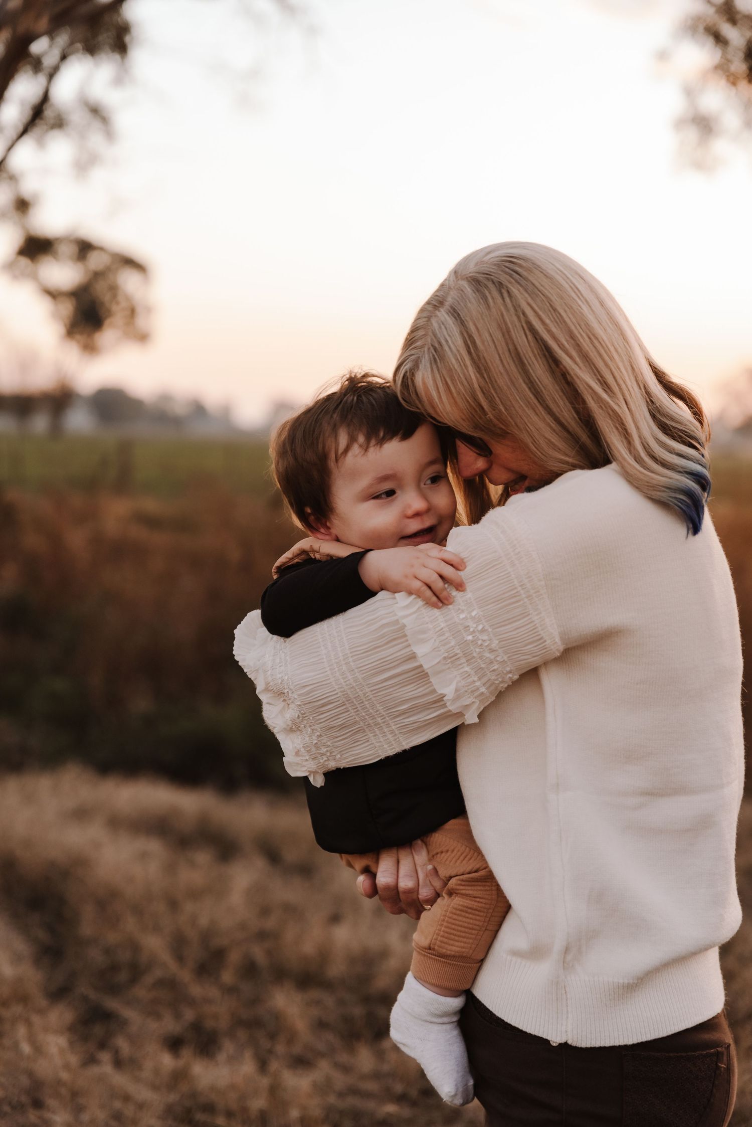 grandma-toddler-playing-in-field-during-golden-hour-tongala