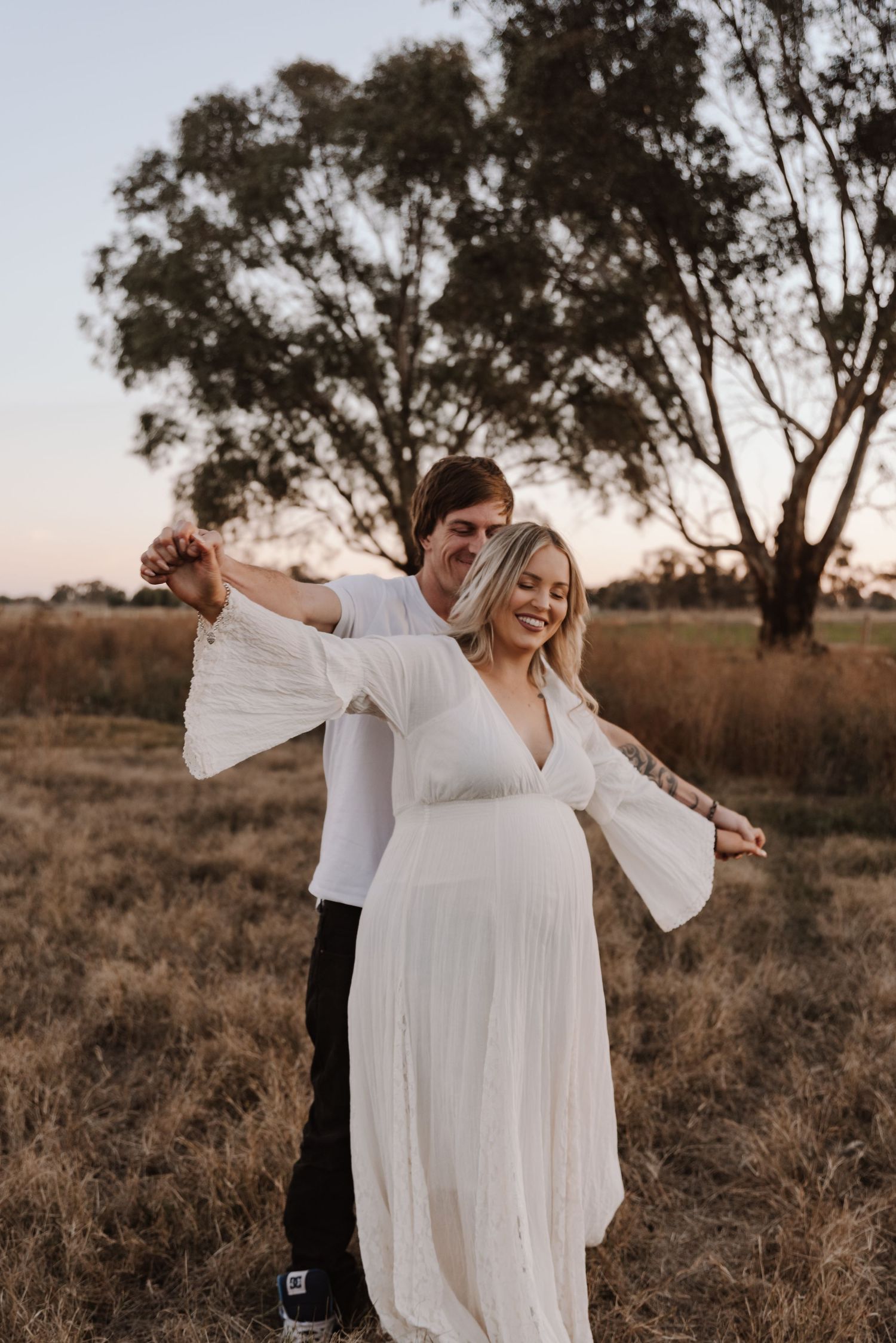 pregnant-mother-standing-in-sunset-field-tongala