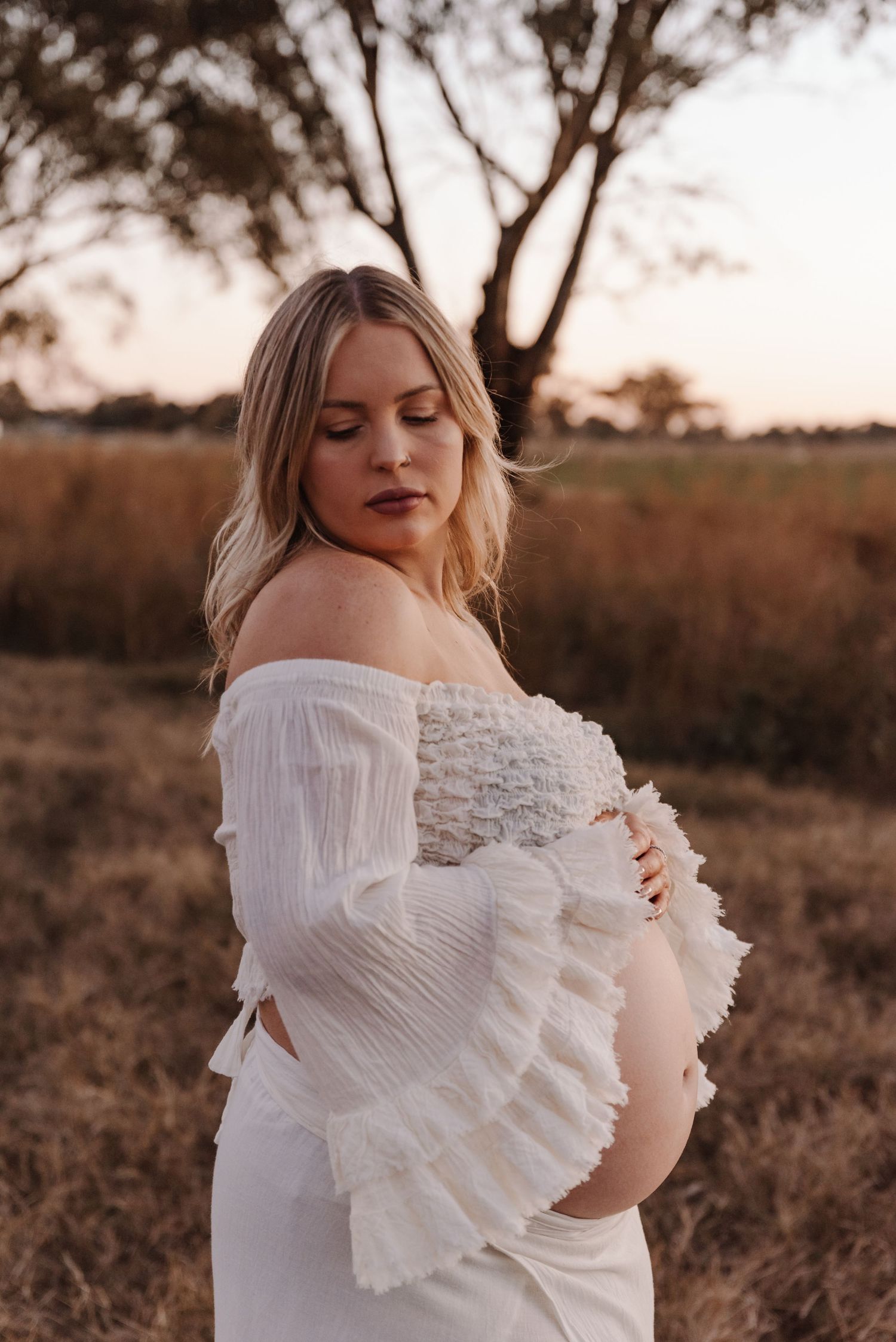 pregnant-mother-standing-in-sunset-field-tongala