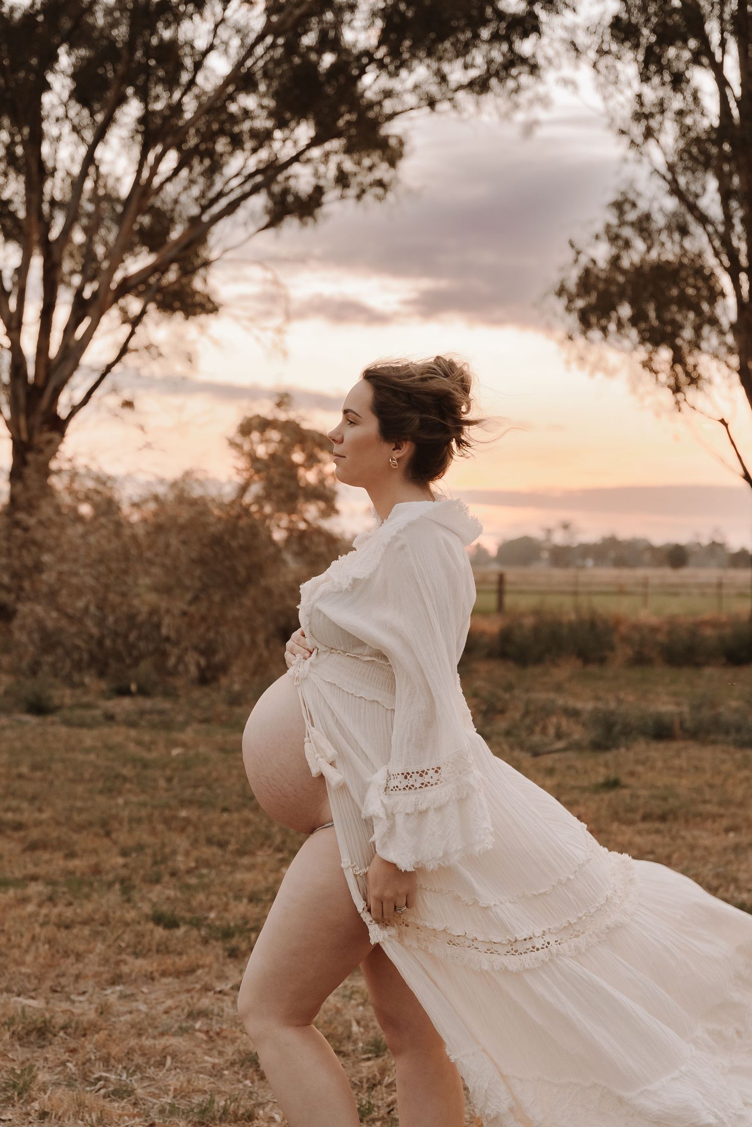 pregnant-mother-standing-in-sunset-field-tongala