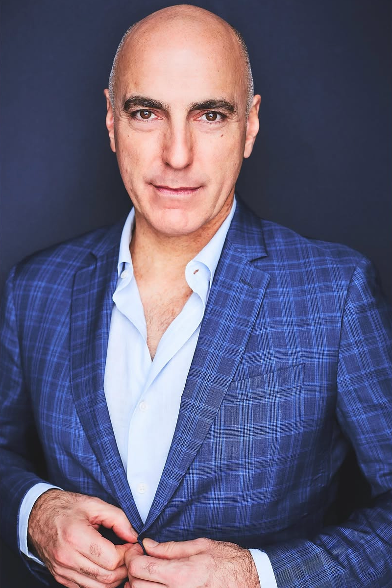 Corporate NYC headshot of a man in a blue suit.