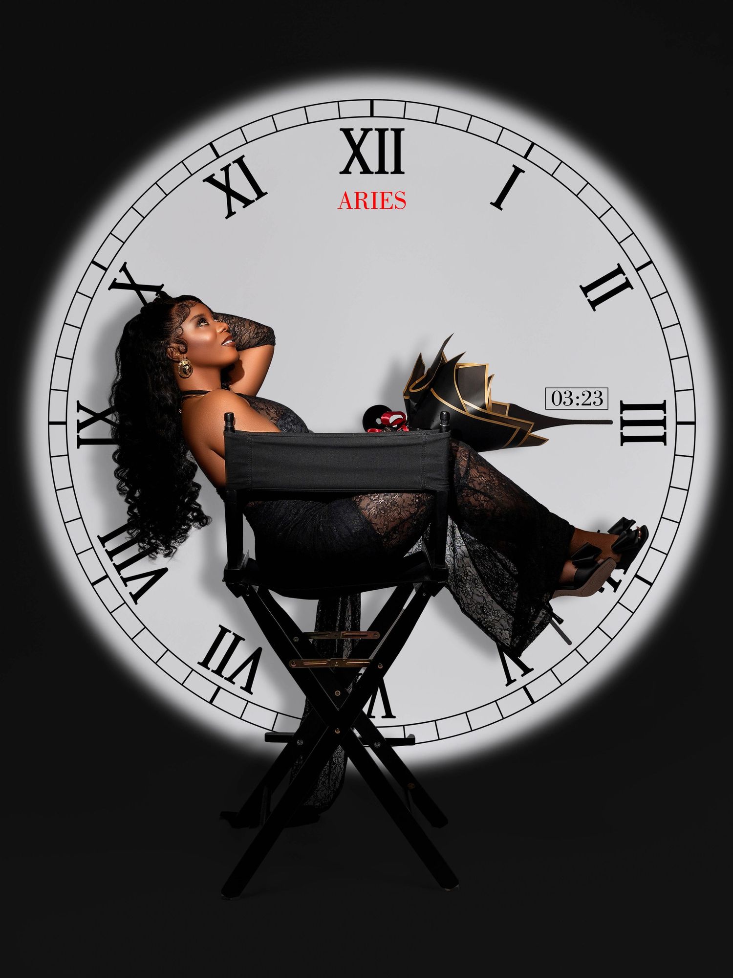 Dramatic clock-themed photoshoot with black dress against a circular clock face backdrop.