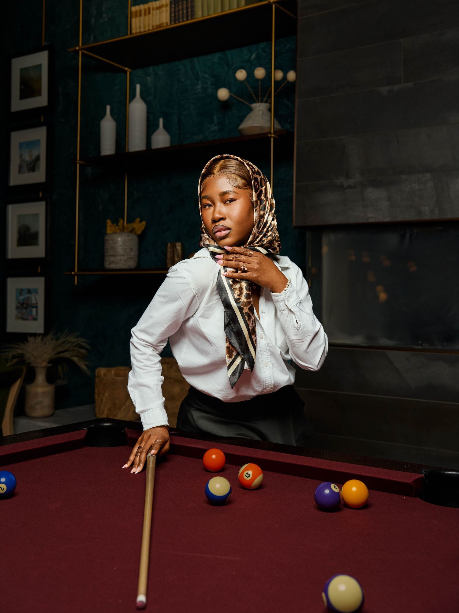 Stylish person playing pool in an upscale venue with modern decor and lighting.