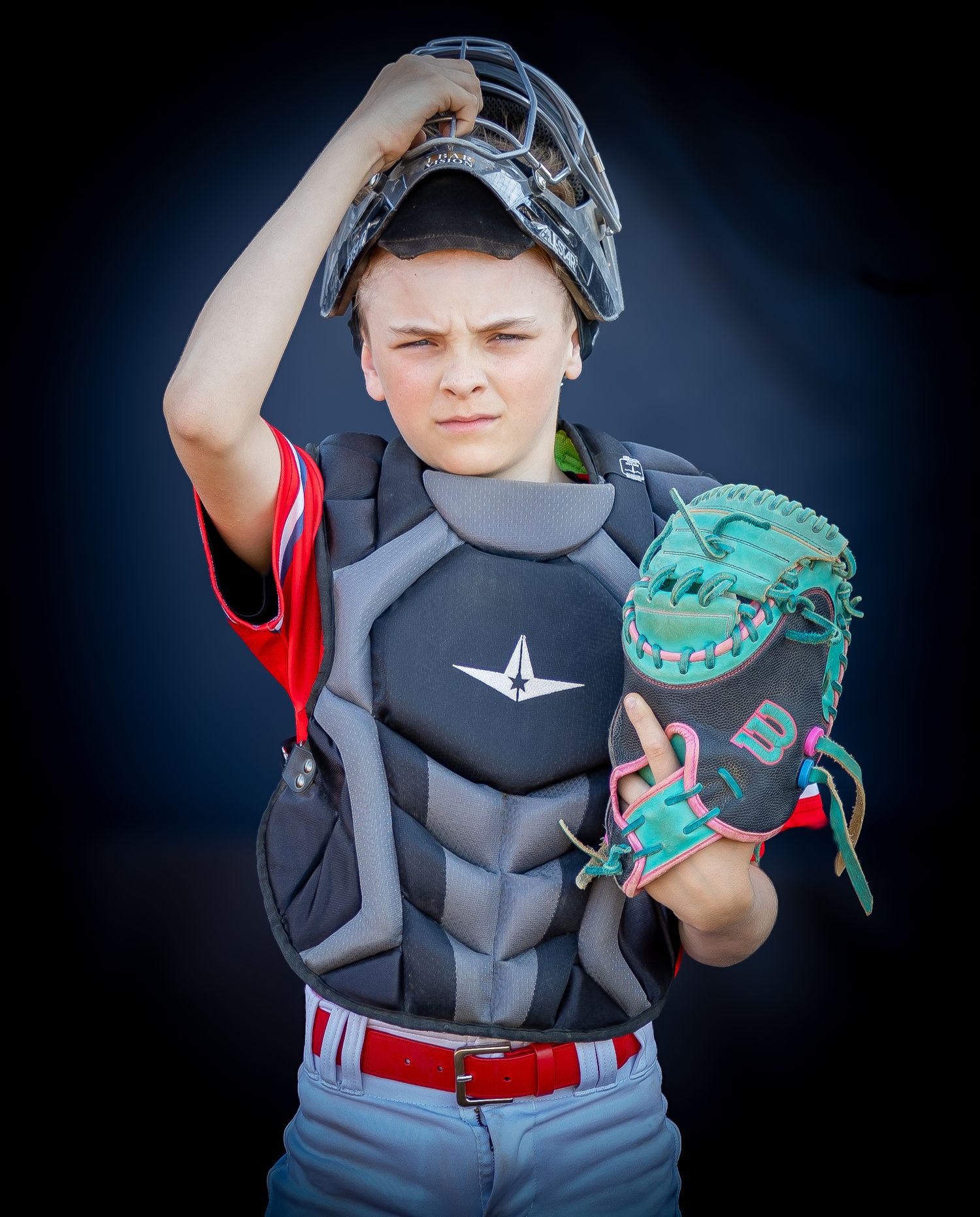 Youth baseball player in protective gear holding a green baseball glove in a series of poses.