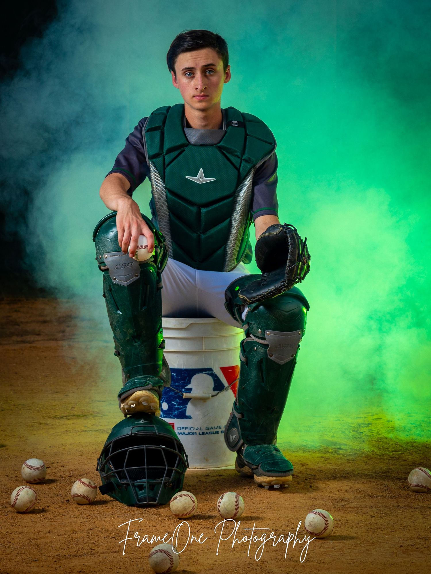 Baseball catcher's gear and equipment arranged with dramatic green smoke effect in professional sports photography setup.