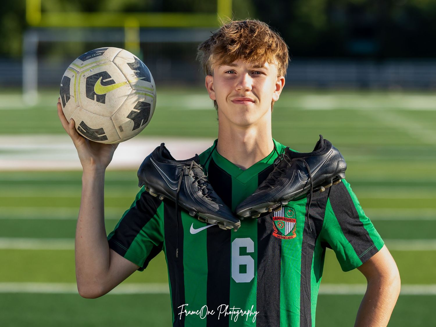 A row of side-by-side football player portrait photos in green and black jerseys posing outdoors on a field.