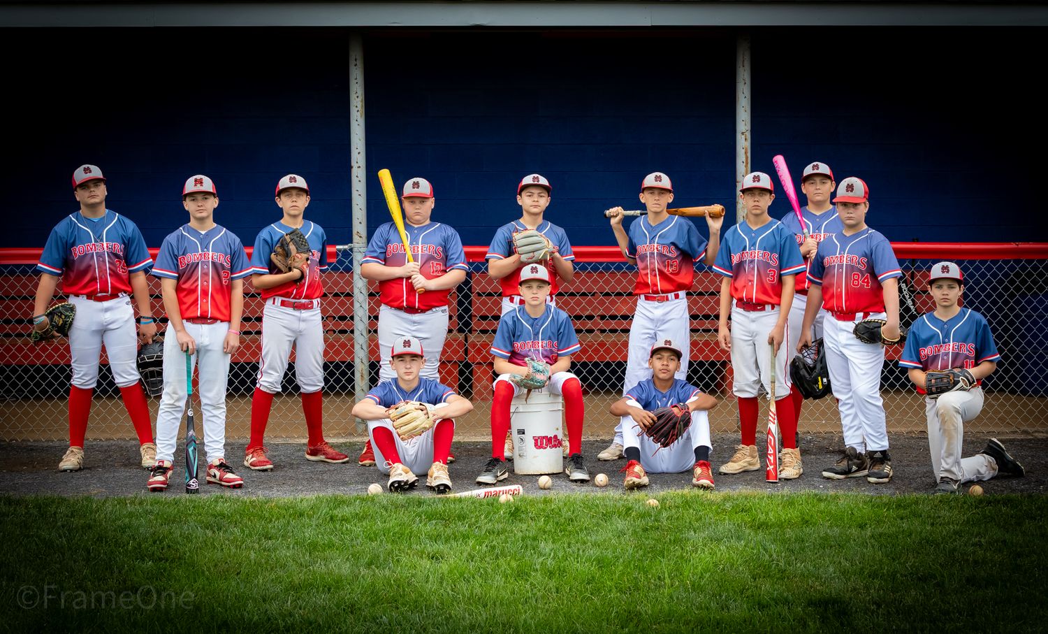 Baseball team photo showing players lined up in blue and white uniforms.