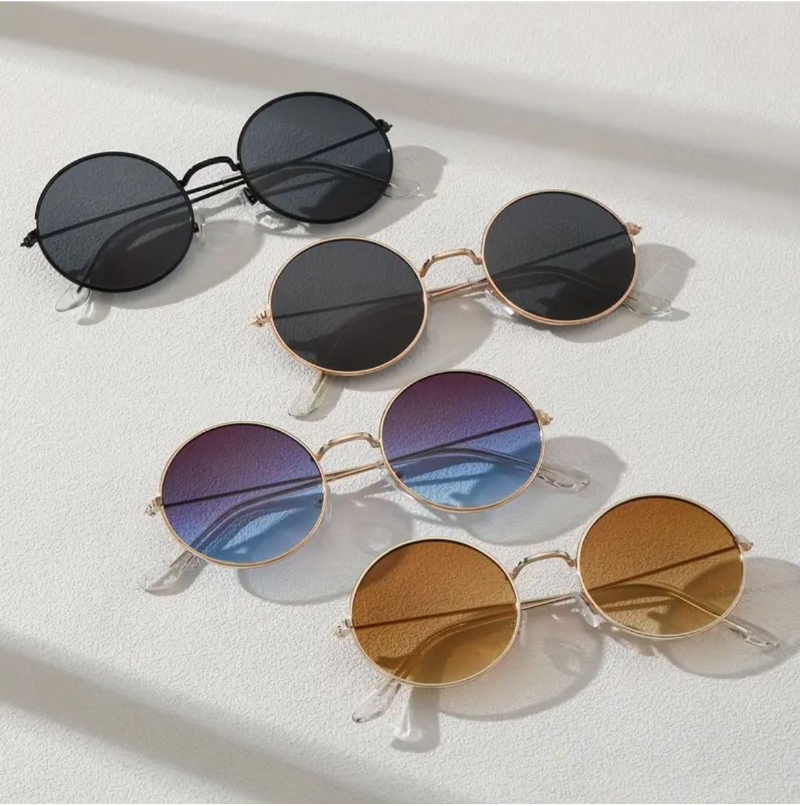Retro round sunglasses in various tints from black to gradient blue and brown.
