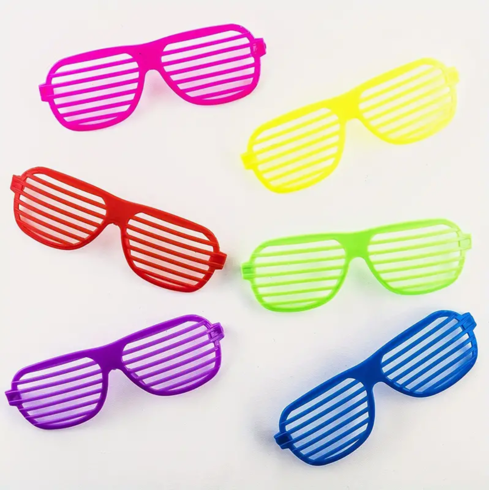 Neon colored shutter shades sunglasses arranged in a rainbow pattern.