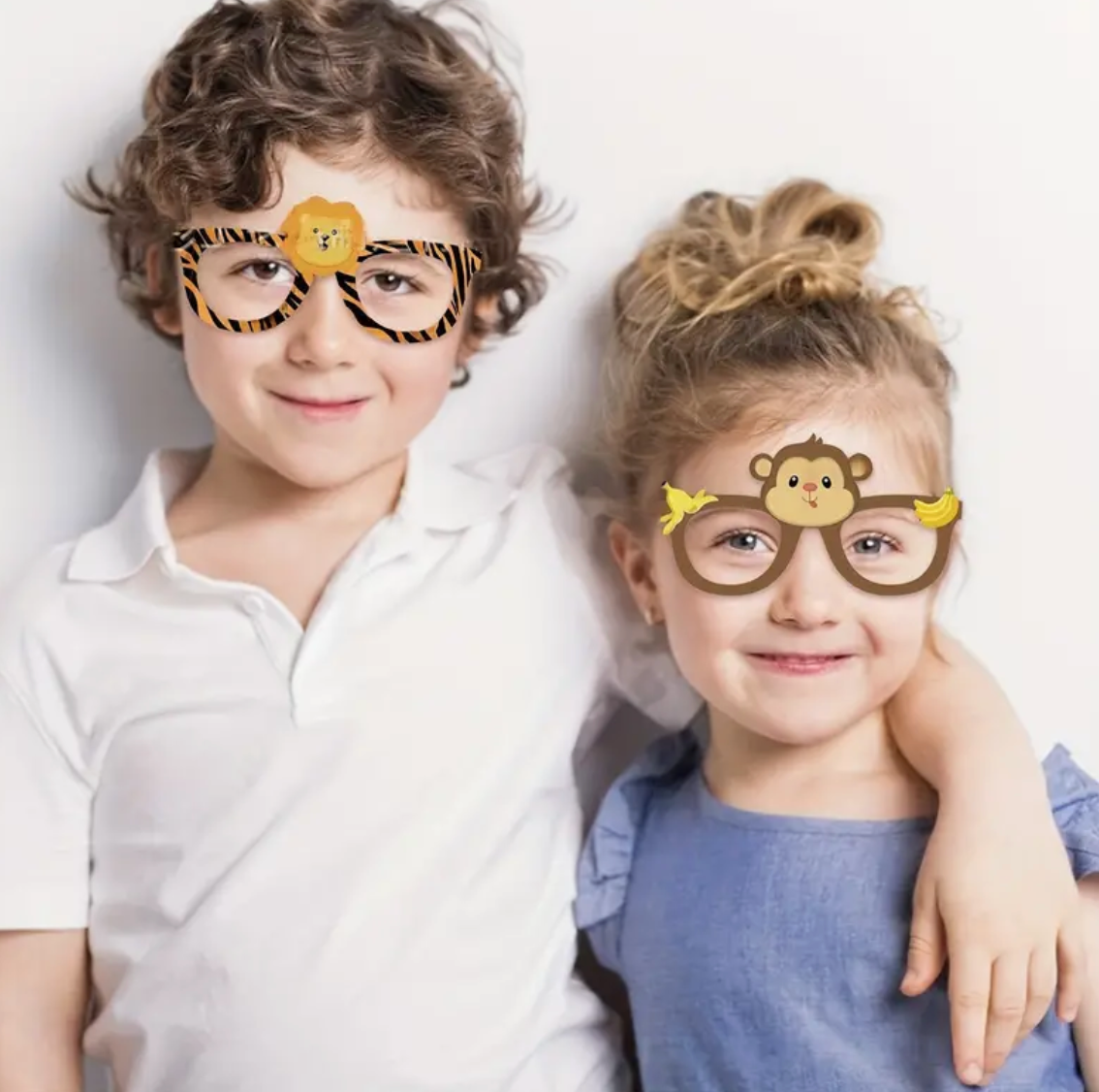 Two children wearing playful character-themed glasses in a casual portrait.