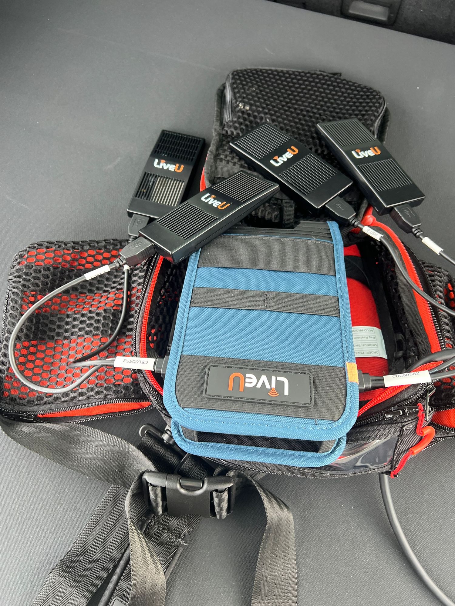A sequence of five photos showing a black and blue sport waist bag with red accents from different angles.