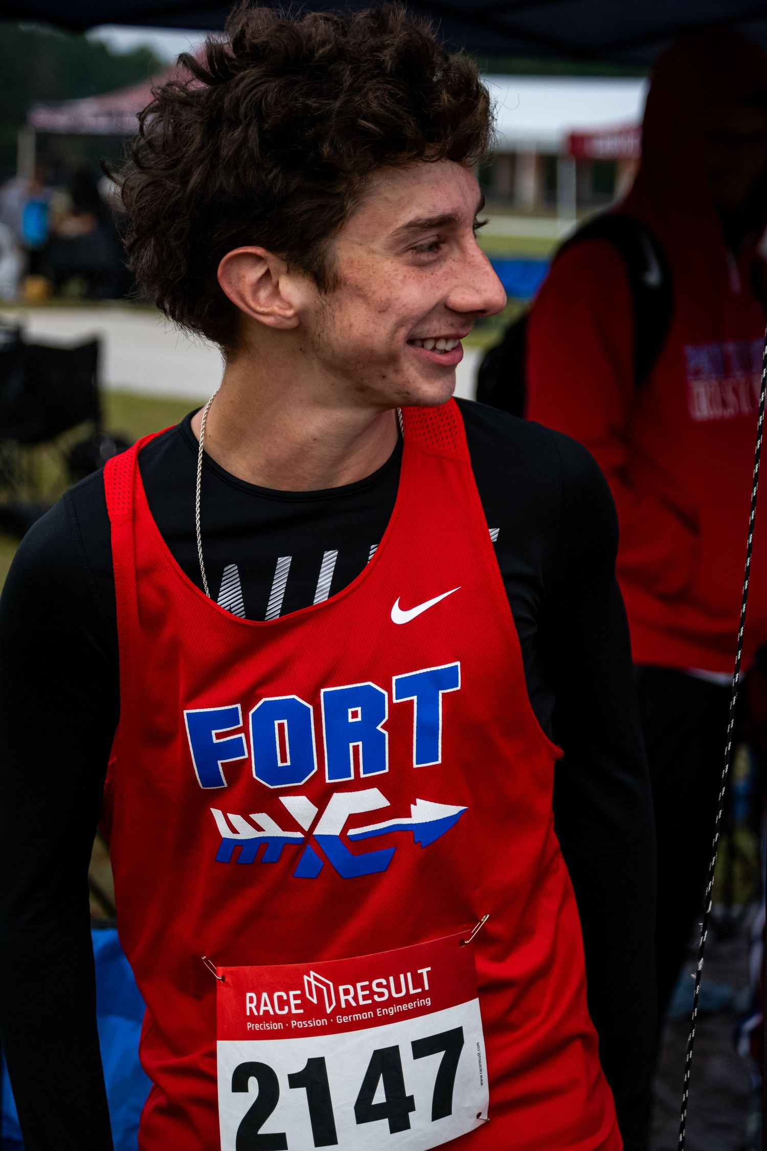 A photo of a man smiling and looking to the side