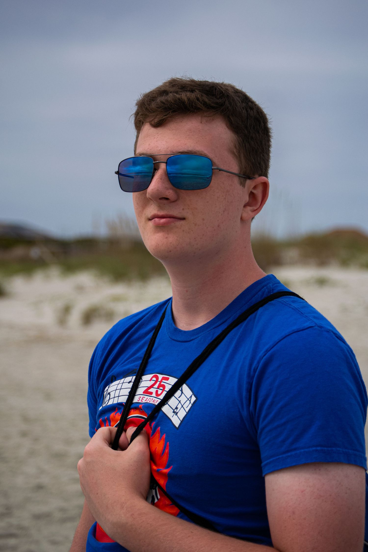 A man posing at a beach