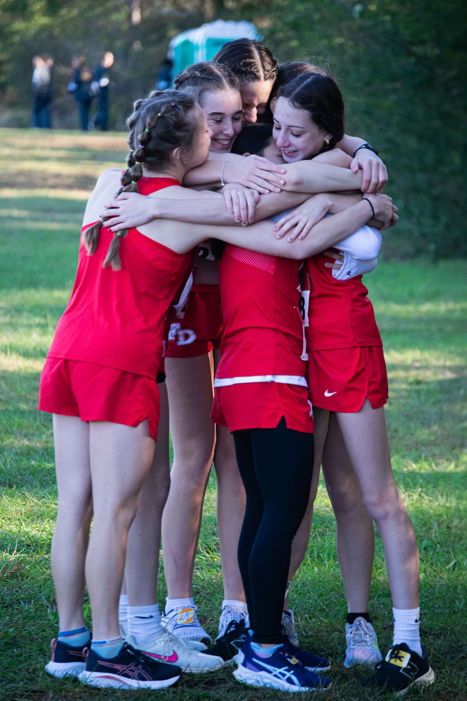 A photo of girls hugging pre-race