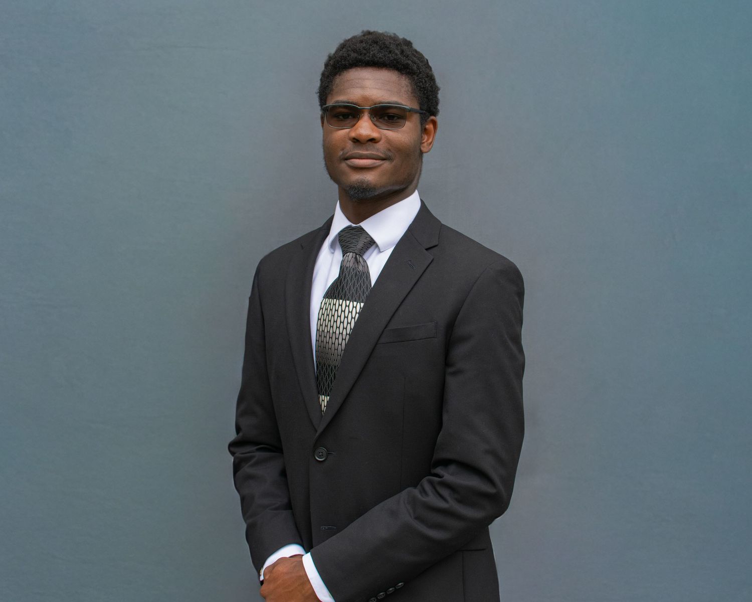 A headshot photo of a man in a suit.